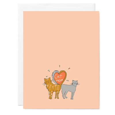 Illustrated greeting card of two cats with tails in shape of heart for mom, pink background, hand lettered words read 'Cat Mom' in heart.
