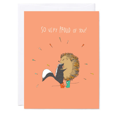 Illustrated greeting card with hedgehog and skunk hugging, reads 'Proud of You'