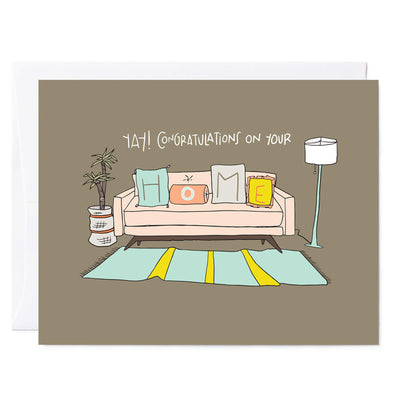 Illustrated housewarming greeting card with drawing of couch, area rug, and floor lamp; couch has throw pillows that have the letters H-O-M-E  on each pillow. Hand lettered words read 'YAY! Congratulations on your HOME.