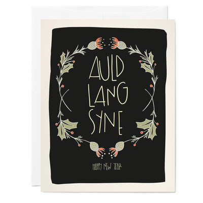 Illustrated holiday greeting card with words saying "Auld Lang Syne" and drawing of floral border around words with holly and Scottish thistles, black background
